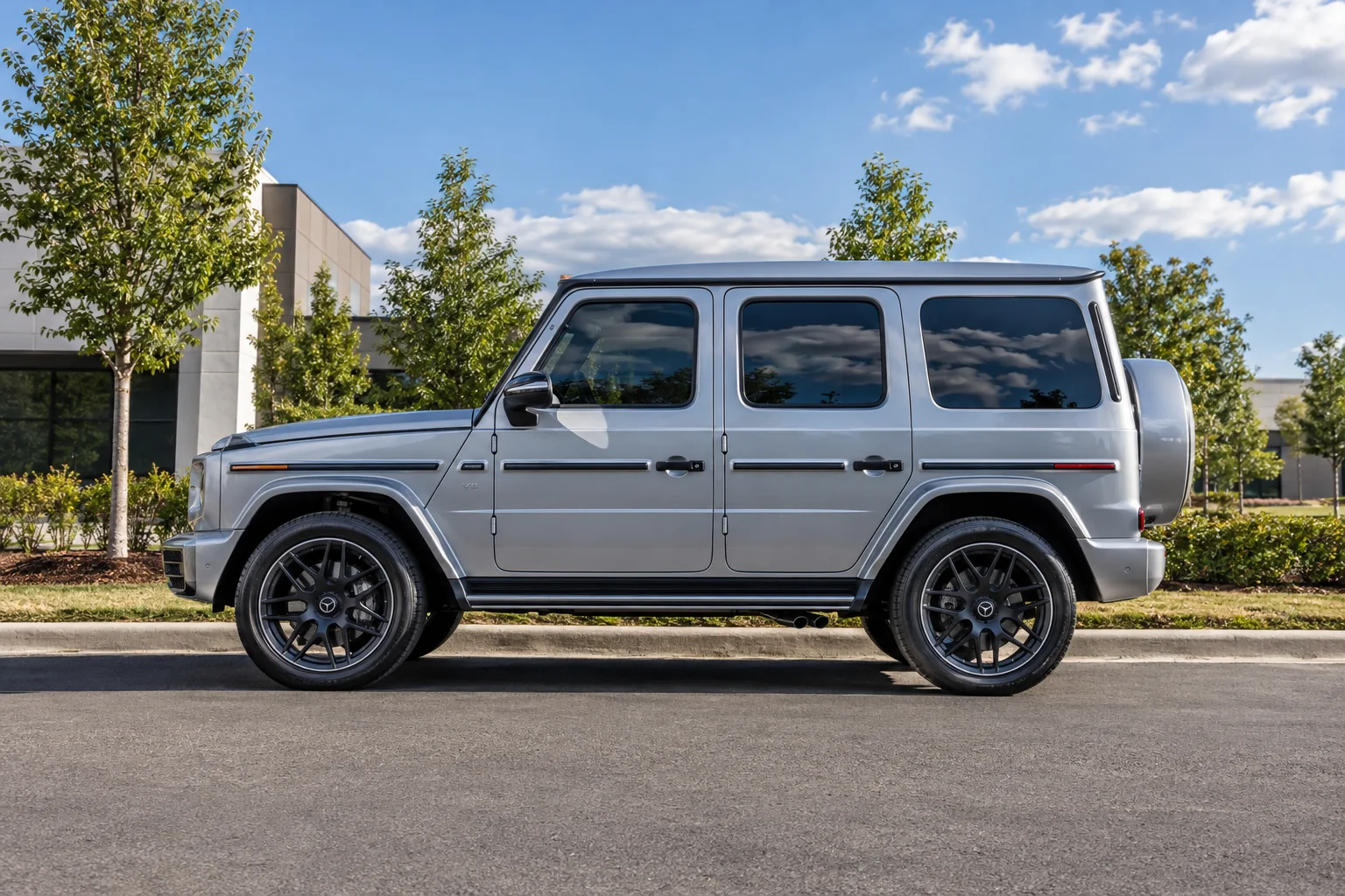 A silver Mercedes-Benz G-Class with tinted windows parked on a street in north Alabama