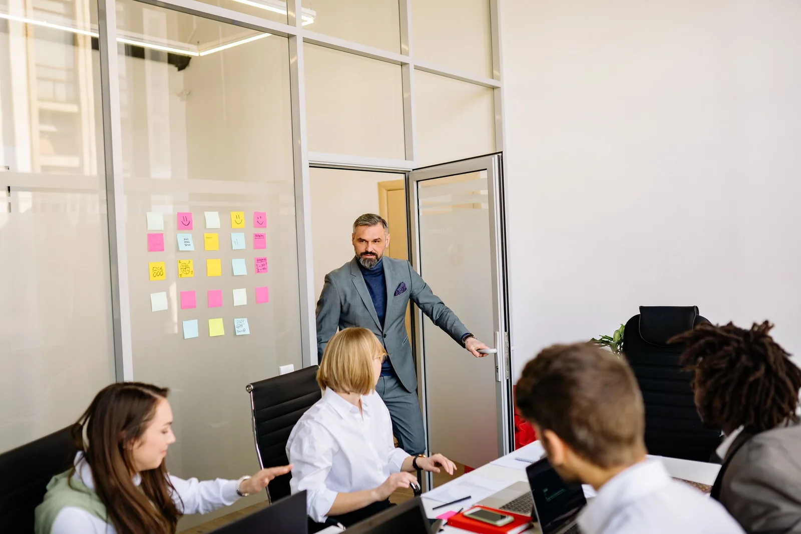 A glass-walled meeting room in an office