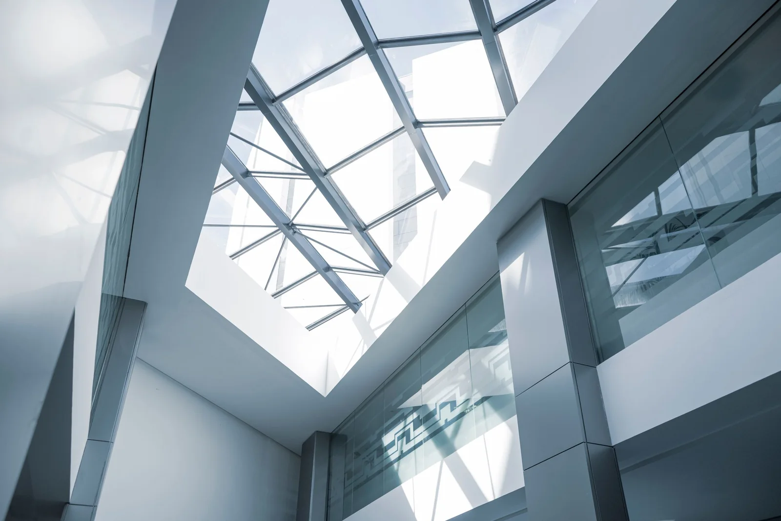 A glass roof over a bright office atrium