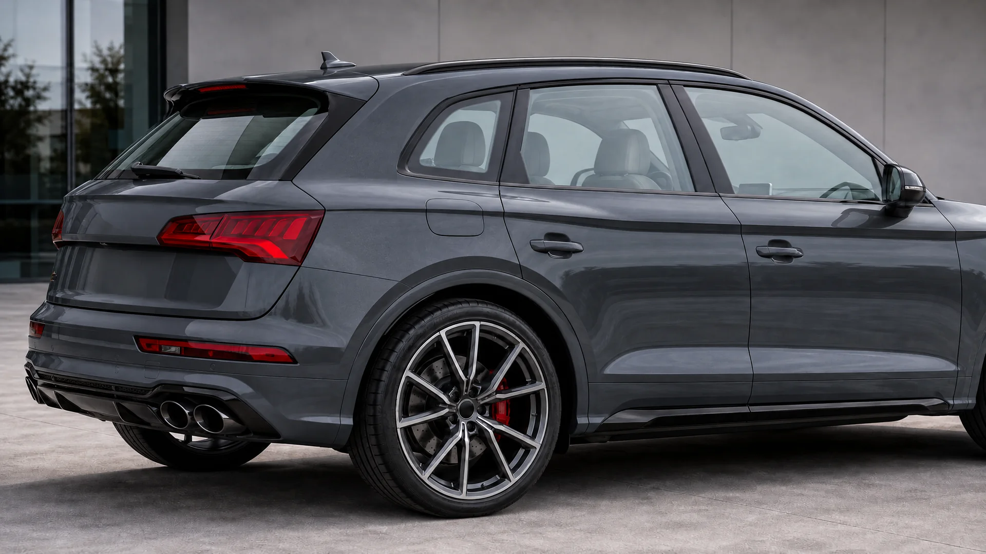 A gray Audi SQ5 with clear glass on one side and Union window film at 35% on the other